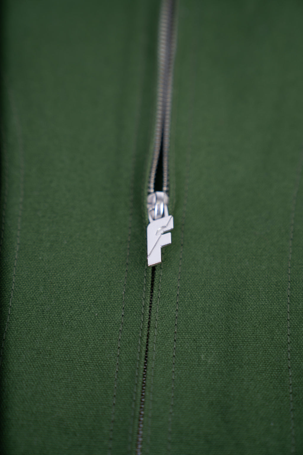 Bandit Jacket by Fades metal zipper detail on green zip-up jacket