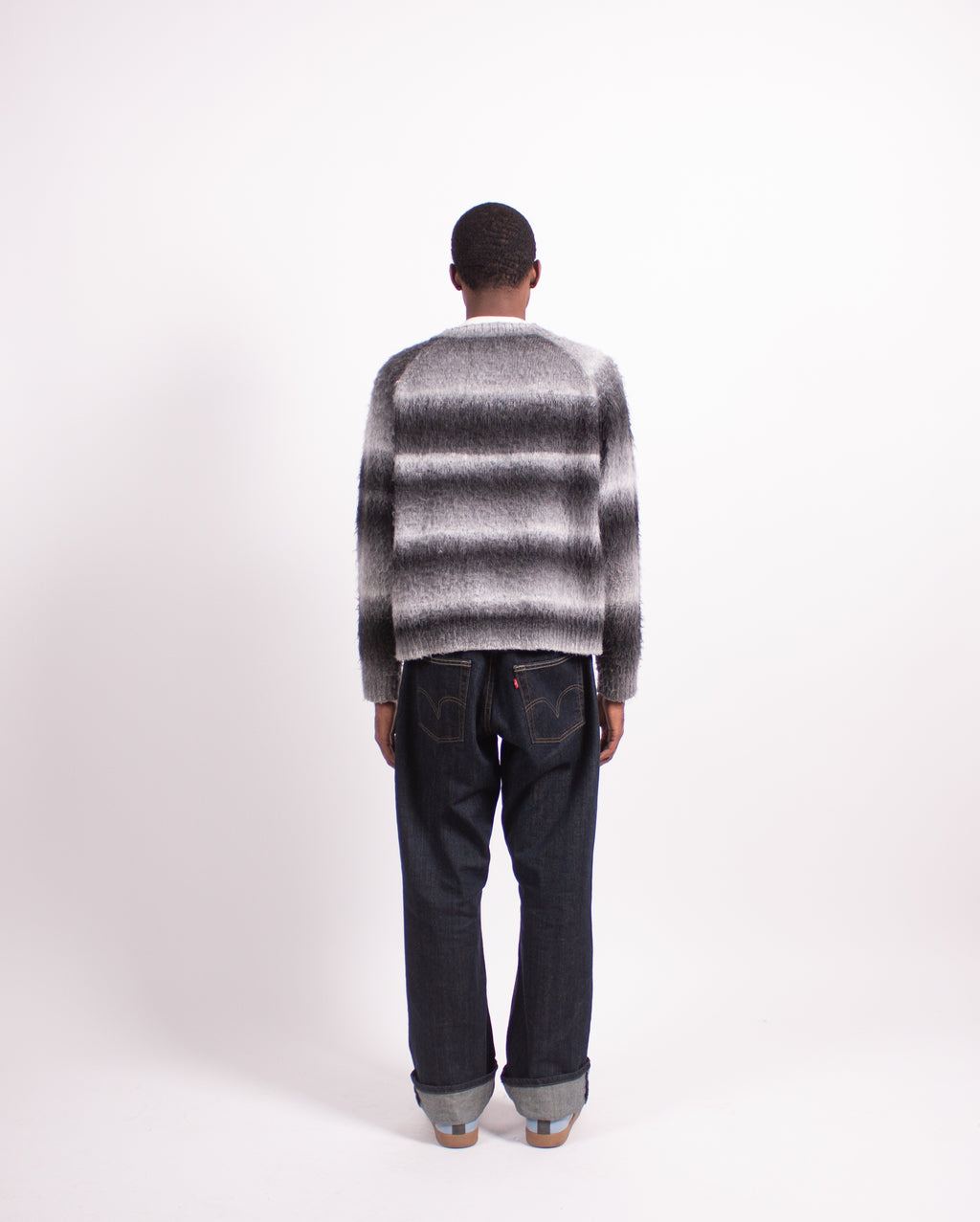 Mountain Sweater Grey by Fades back view of grey sweater worn by model